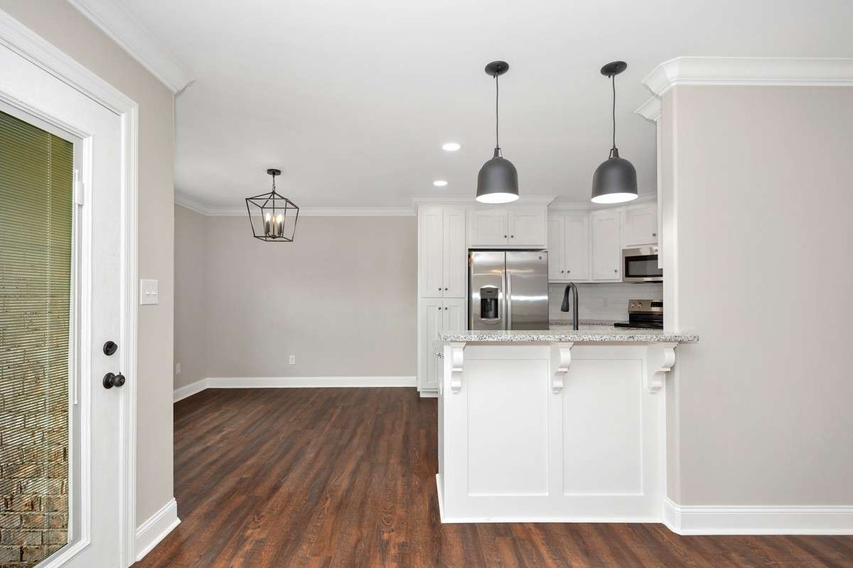 Dining Room/Kitchen- LVP flooring, crown molding, recessed lighting, granite countertops
