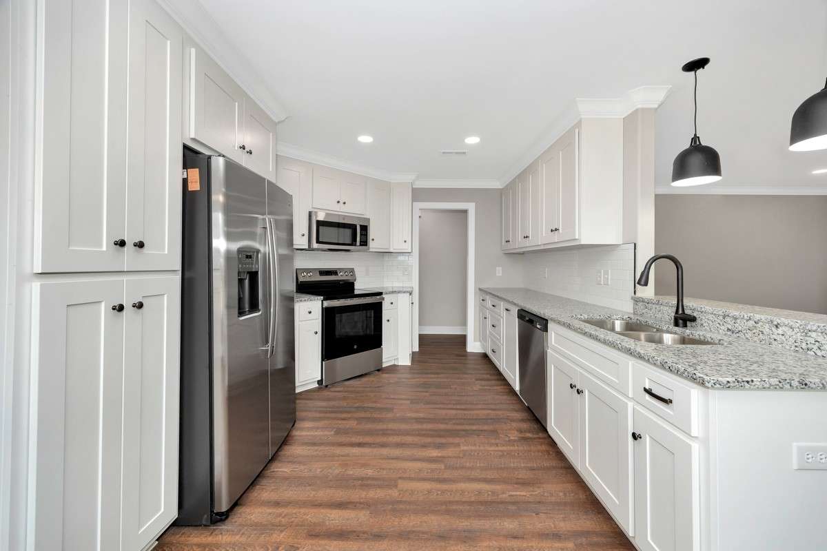 Kitchen- LVP flooring, granite countertops, pantry, recessed lighting, stainless steel appliances- dishwasher, refrigerator, stove/oven, microwave, crown molding