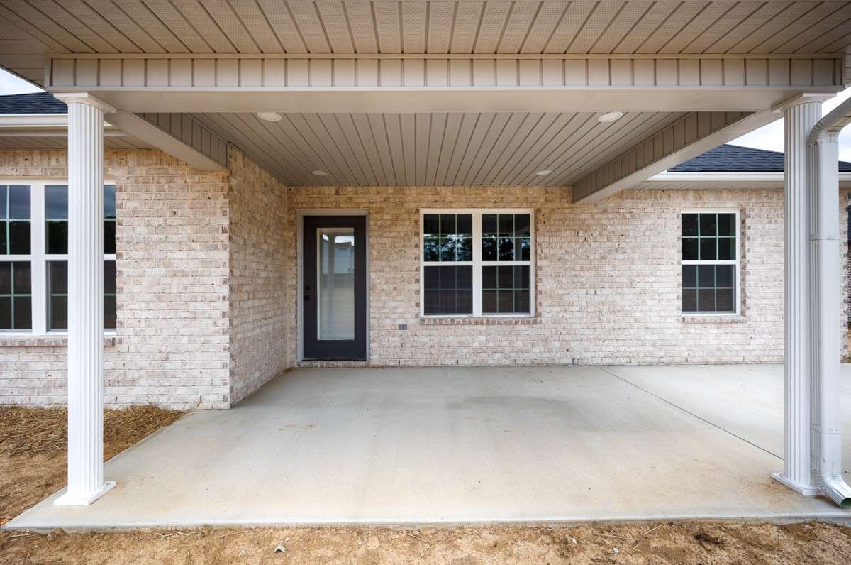 Back of house- covered patio with home entry, open patio