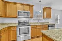 Gas line capped and ready behind current electric oven - easy conversion to gas if desired.