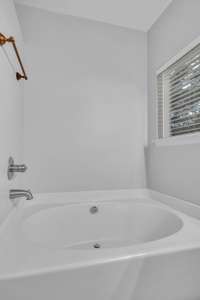 Alcove tub with handy deck surround and wall-mounted faucet