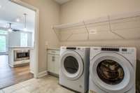 LARGE LAUNDRY ROOM WITH COUNTER TOP AND CABINET. EXTRA STORAGE SPACE IN CLOSET