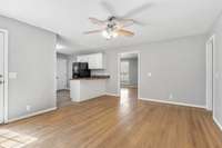 Kitchen with bar seating opens to this room.