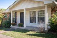 A covered front porch ready for your fall decorations!