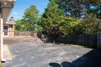 The deck has entry to the paved parking and also to the fenced backyard.