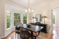 Notice the bay window that overlooks the lush treeline from the dining room