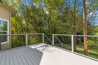 Newly-added wooden back deck overlooking an expansive, open lot. Lot may be fenced with HOA approval