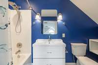 Updated, contemporary bathroom with tub/shower combo and single vanity