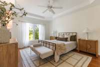 Expansive primary suite with tray ceiling — attached to large en suite bathrom