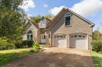 Welcome to 8013 Boone Trace in Bellevue. Exterior roses will bloom in the spring along the house.