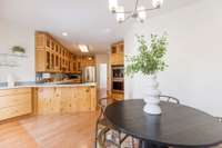 The kitchen features true hardwood to-the-ceiling cabinetry and an induction range