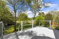 Brand new back deck overlooking the spacious, tree lined lot