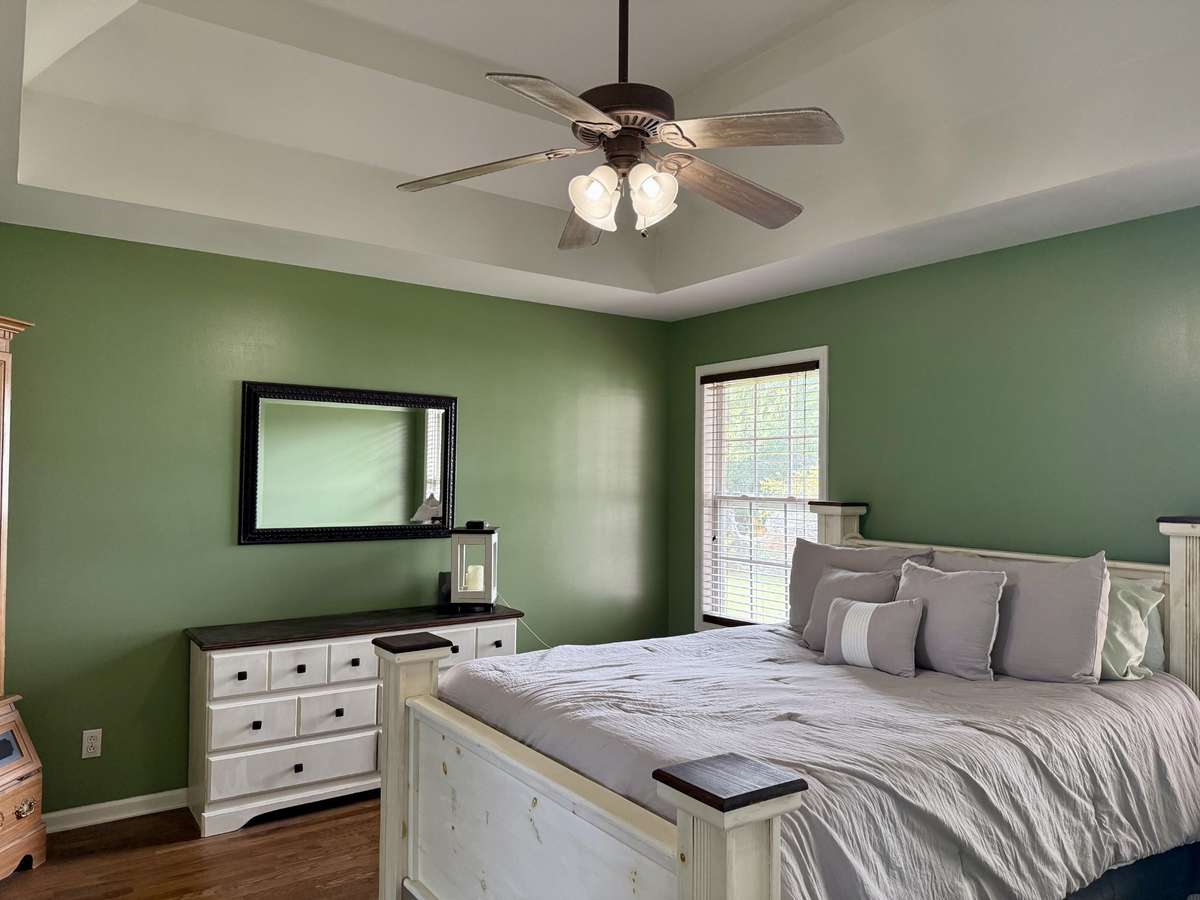 Primary bedroom with high ceiling.