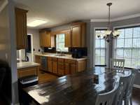 Eat in kitchen with stove, dishwasher, and fridge.