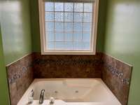 Jacuzzi tub in primary bathroom.