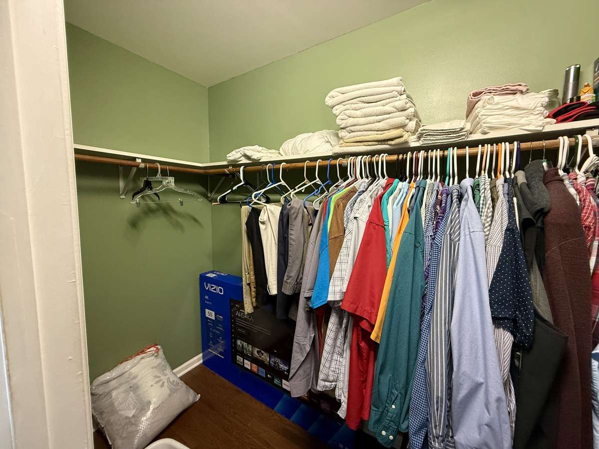 Walk-in closet in primary bedroom.
