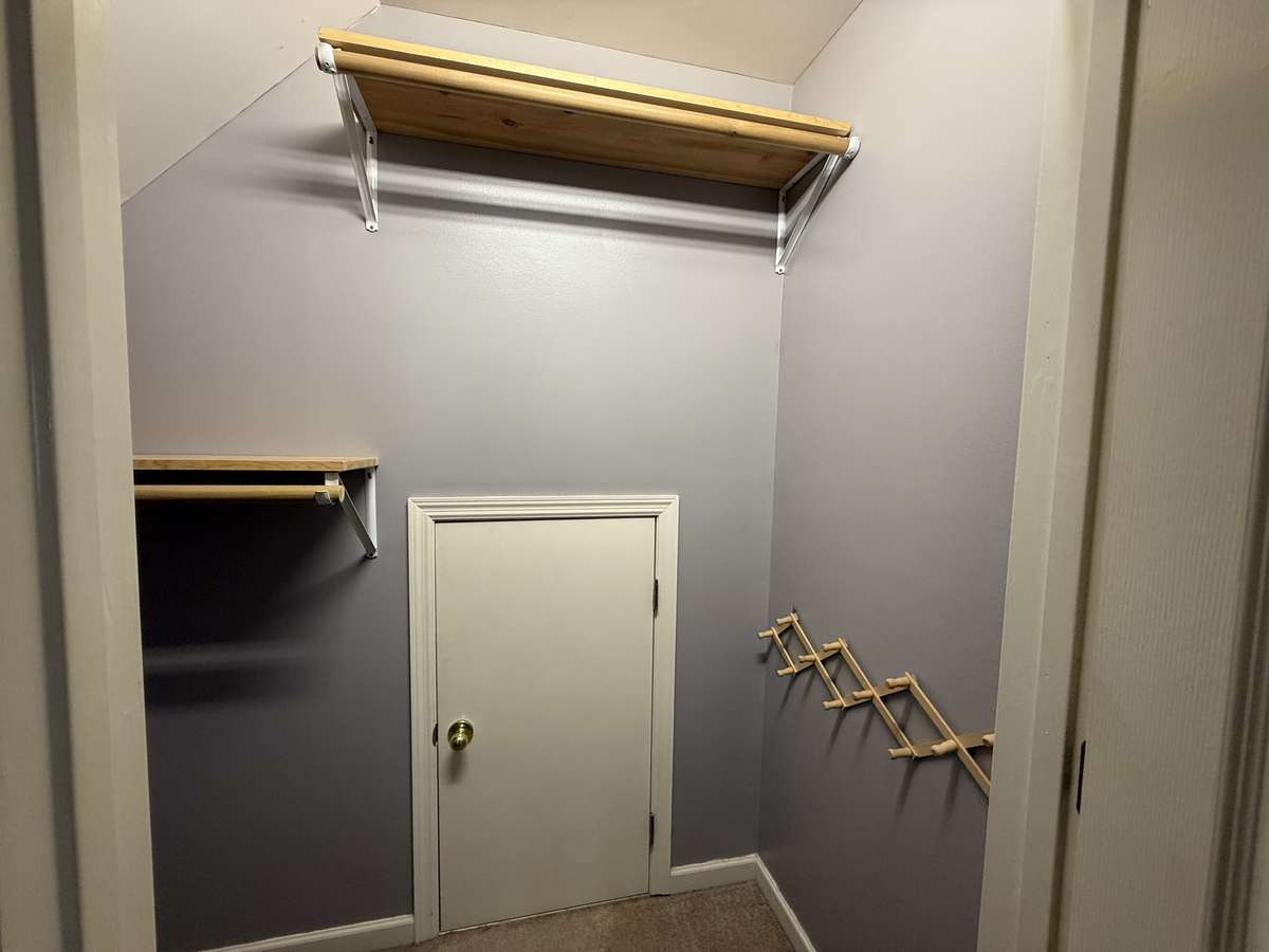 Upstairs walk-in closet with access to the attic.