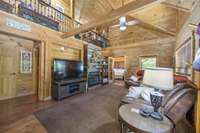 Living Room - Hardwood Floors, Vaulted Ceiling, Gas Fireplace – Double Sided To Primary Bedroom, Custom Made Wrought Iron Railings