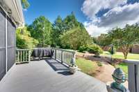 deck area off the screened porch allows for outdoor cooking, catching some sun and a beautiful view of the private back yard with rolling hills in background