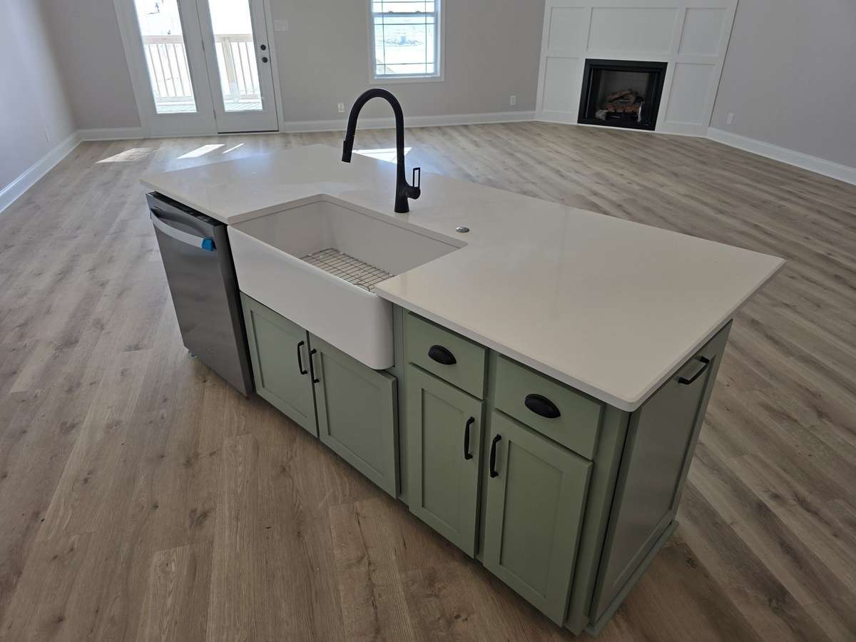 Quartz Countertop with Farmhouse sink. There is also a built-in garbage can.