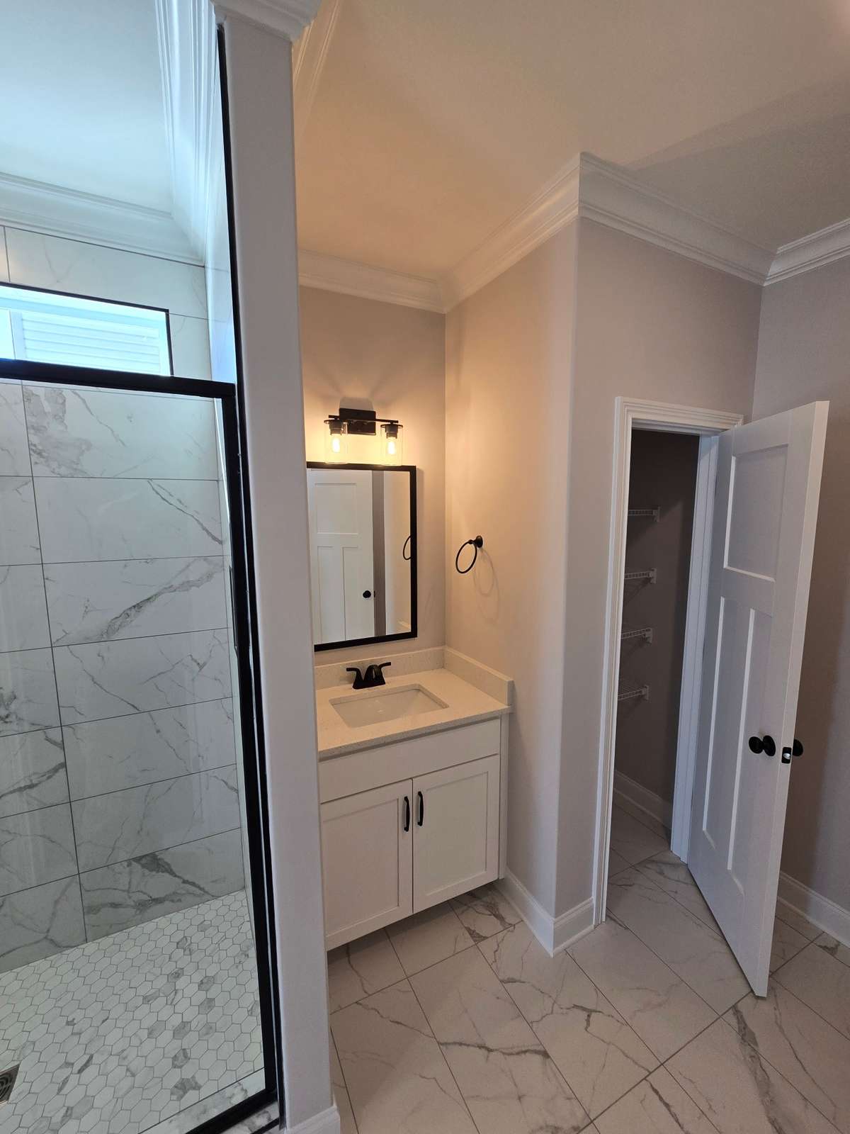 Another caption of the master bath with linen closet.