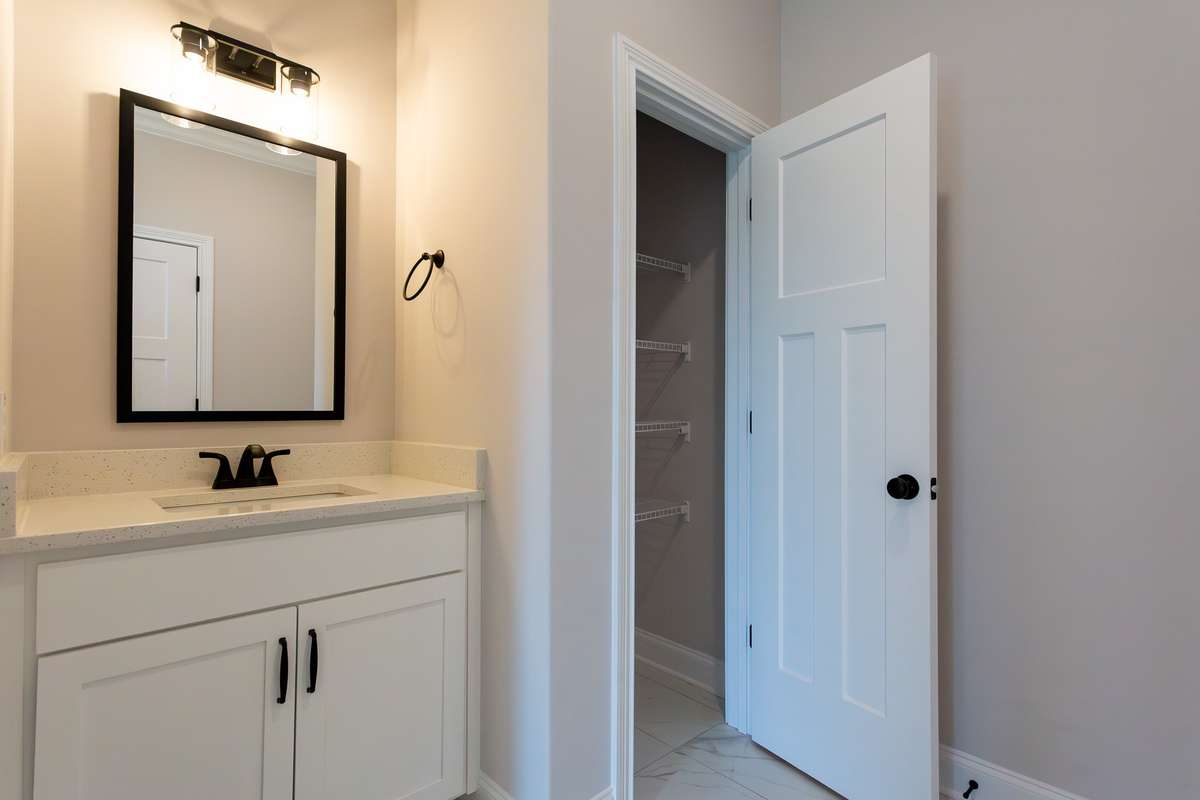 Linen Closet in Master bathroom. Quartz Countertops.