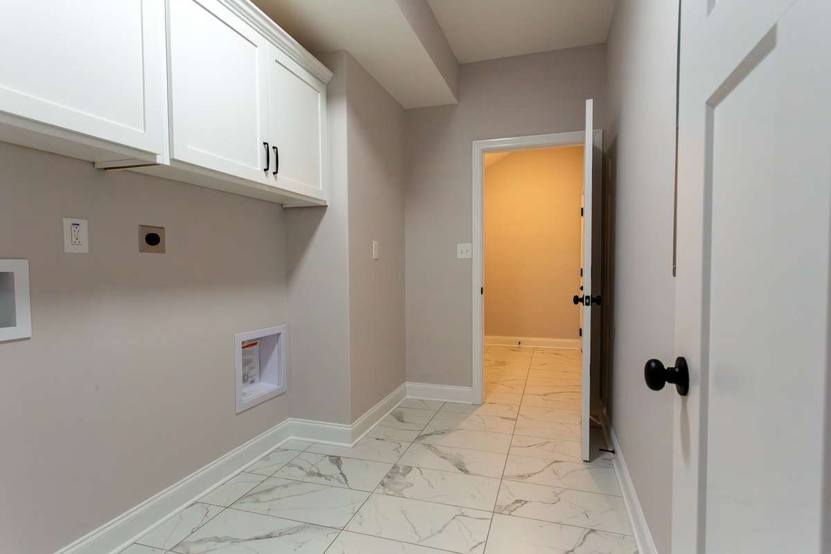 Part of the laundry room. Where you see the door at the end is more of the laundry room. Ideally located from the garage entrance.