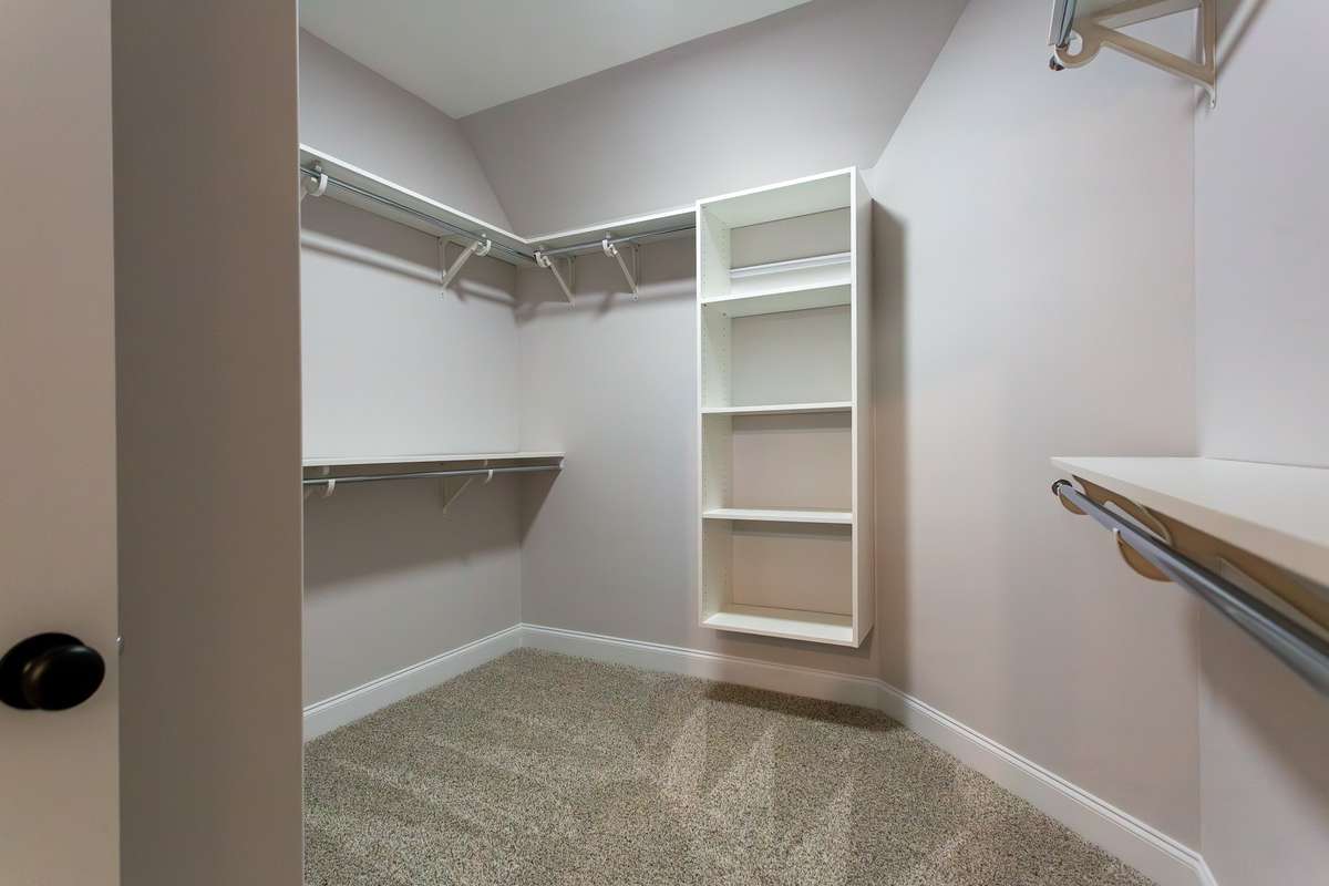 There are 2 master closets. This is the larger one with wooden shelving.