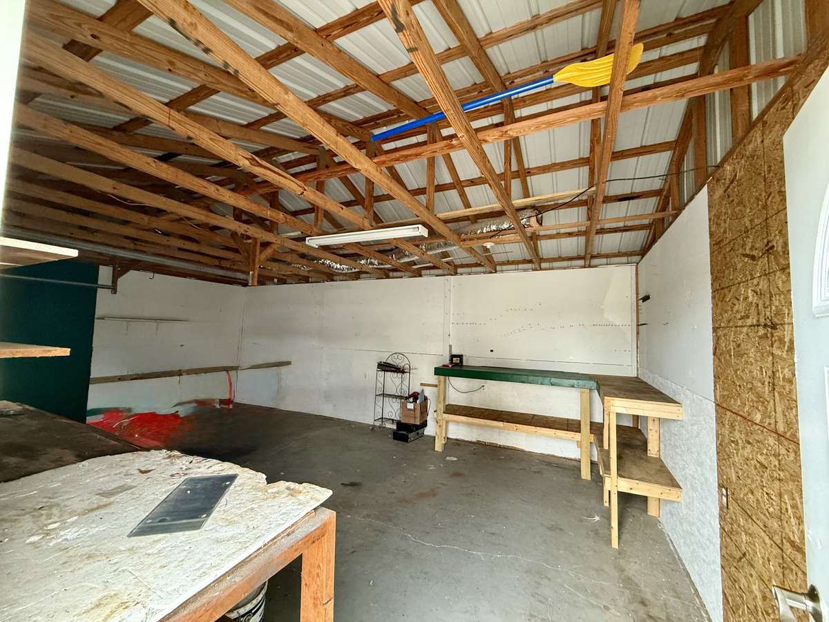 Great little workshop with concrete floor and 1 bay door with 384+/- SF