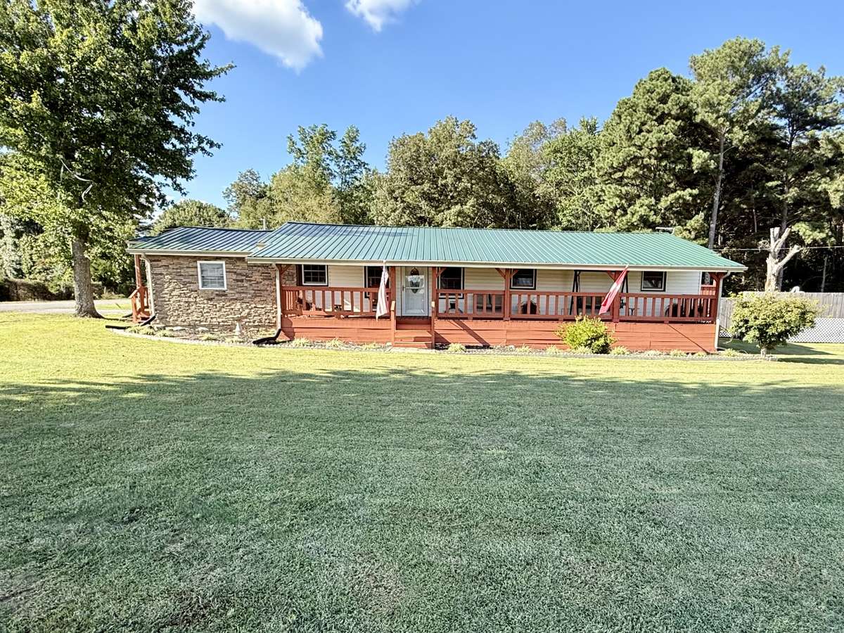 This renovated home sits on approximately 1.4 of an acre surrounded by neighboring trees and farmland with a view of the Cumberland Plateau in the distance.