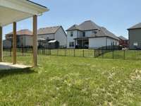 Yard is completely fenced in with the rod iron, HOA approved fencing.