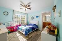 The other 2 bedrooms are located on the right side of the home . Bedroom 2 at the front of the home has a large walk-in closet, ceiling fan, and its own private sink space for the Jack-in-Jill bathroom.