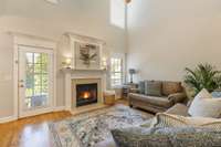 Alternate view of this living area with upper windows for added sunlight and a backdoor to your back patio