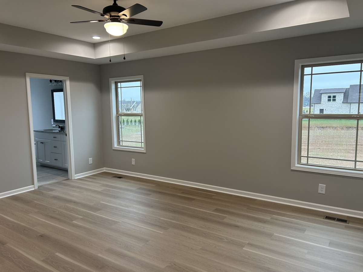 Primary bedroom with Tray ceilings and double windows for natural sunlight!!