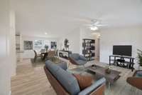 Living and Dining areas and the hallway leading to 3 bedrooms (virtually staged)