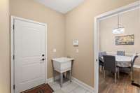 Sink in hallway by garage door.