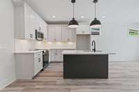 This modern kitchen has beautiful black color pop, & an island - perfect for entertaining, featuring a farmhouse sink. 5511 Urbandale Ave Nashville, TN 37209