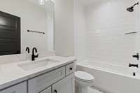 Private bathroom with oversized single vanity with quartz countertop, tile floor, & tiled combo tub & shower. 5511 Urbandale Ave Nashville, TN 37209