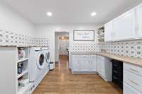 Huge laundry room with counter space! Washer and dryer stays with house