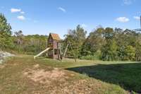 Wooden play structure remains with the home.