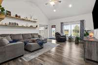 Spacious living room with vaulted ceilings and abundant natural light.