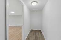 The closet floor matches the rest of the downstairs flooring.  The lighting in this photo just makes it look darker.