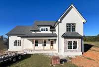 Covered front porch and stone accents on the exterior of the home