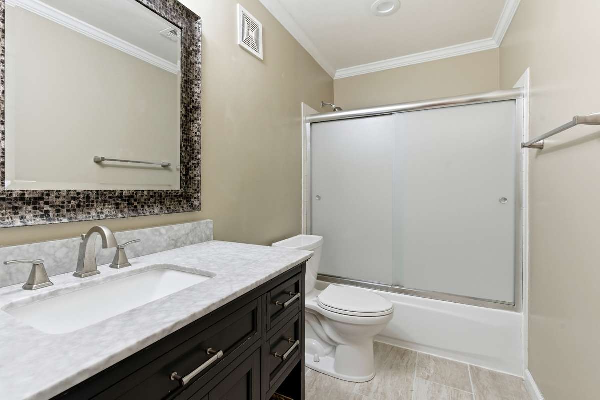 The hall bath has been completely renovated, taking out the wall between the tub, toilet, and vanity, giving this bathroom MORE room!