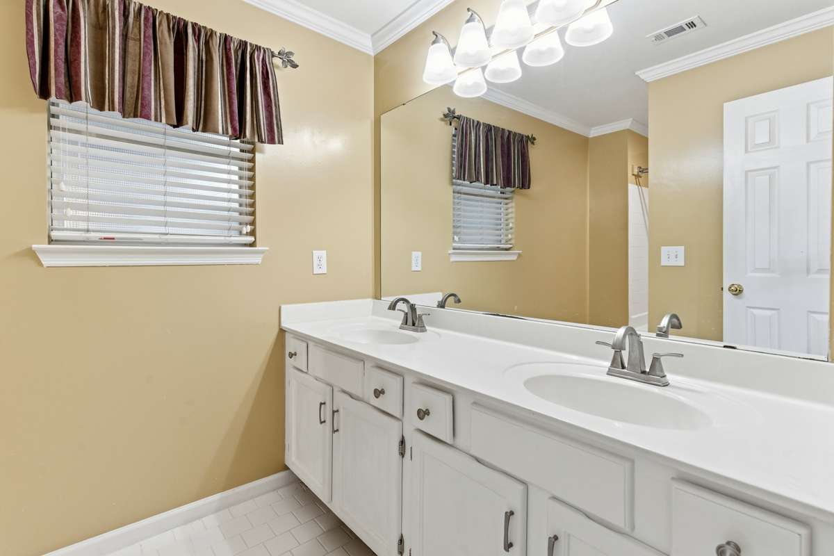 The primary bathroom vanity has been raised and renovated