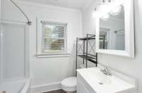 Across the living space you'll find a full, bright bathroom as you enter the hallway. New plumbing has been installed throughout the house for all incoming pipes and connections!