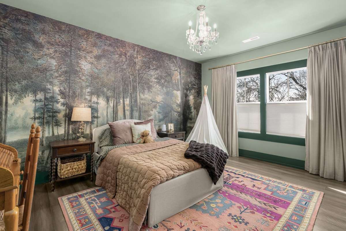 A magical retreat where imagination takes center stage—from the whimsical forest mural to the soft chandelier glow, every detail creates a space for dreaming, reading, and growing.