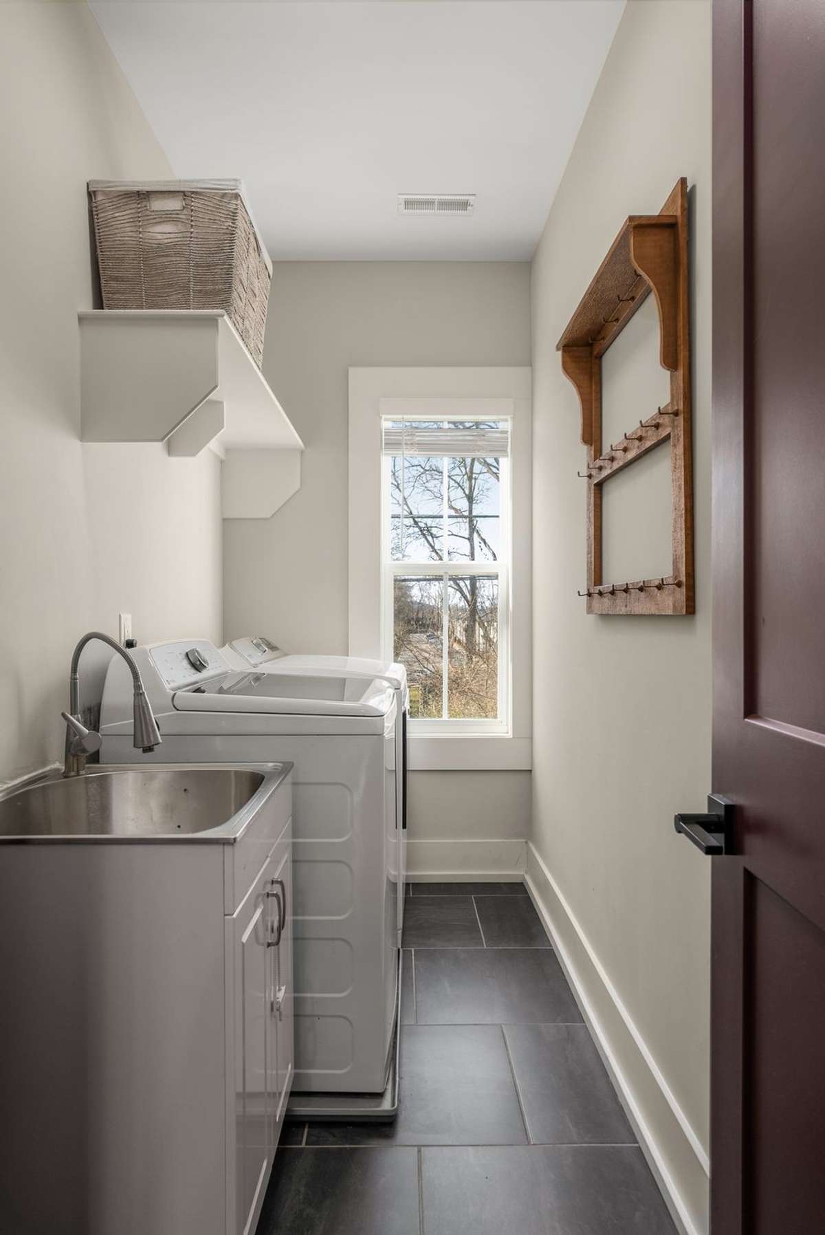 A bright, airy laundry room designed to make everyday routines feel effortless—with smart storage and space to stay organized.