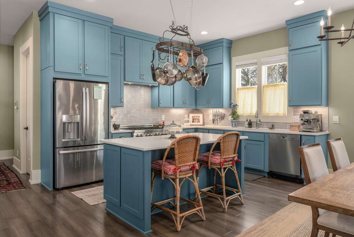 A chef’s kitchen with stainless steel appliances, custom cabinetry, and a generous island—beautifully designed for real cooking and easy hosting.