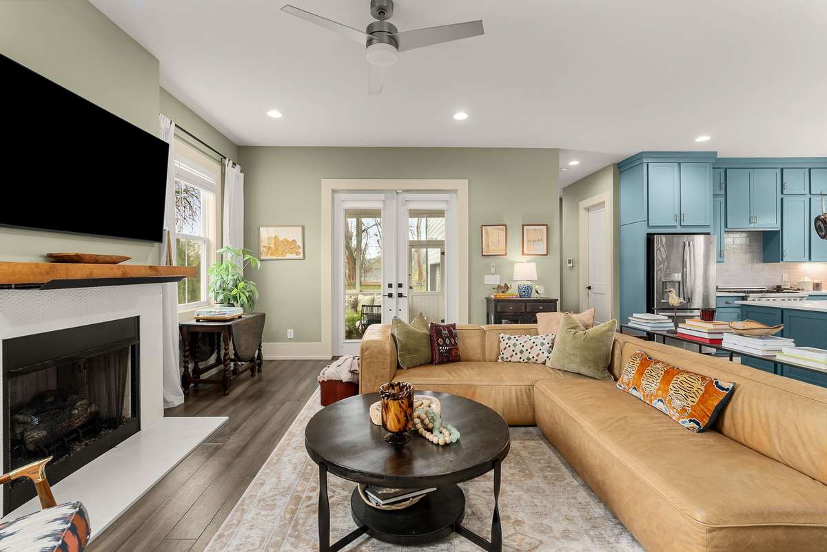 Open and connected by design—where the kitchen, living area, and fireplace come together for easy conversation and everyday ease.